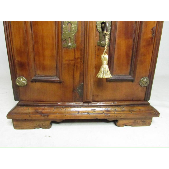 18th Century Italian table top collectors cabinet, c.1750 Made of walnut with two paneled doors that open to reveal a...