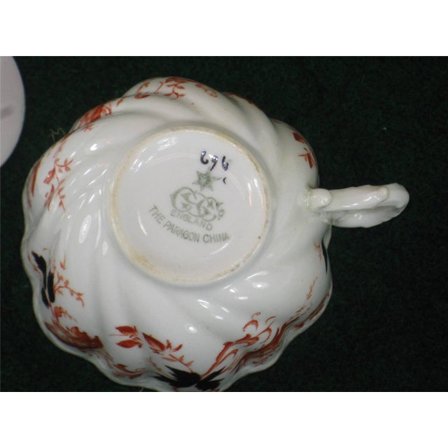 An antique Paragon China teacup and saucer set made in England between 1850-1899. This fine bone china set features a gold...