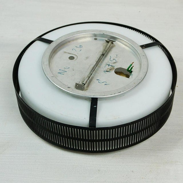 This Austrian midcentury Circular wall or ceiling lamp was produced in Austria in the 1960s, probaaly by Rupert Nikoll. It...