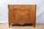 An antique commode, early 19th century, French. Empire / Neoclassical style featuring intricate parquetry, original brass...