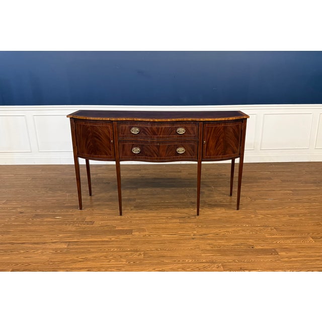 This is a traditional Hepplewhite Style Mahogany Sideboard by Leighton Hall. Its design was inspired by the Hepplewhite...