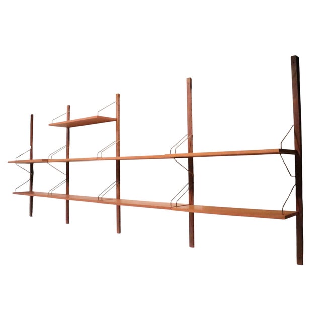 Classic Mid Century Danish Modern wall mount shelving unit, consisting of five vertical supports, and nine shelves, in two...