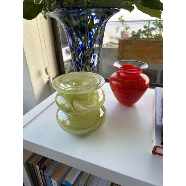 Handblown studio glass vase in a luminous chartreuse green with soft marbled movement through the glass. Sculptural double...