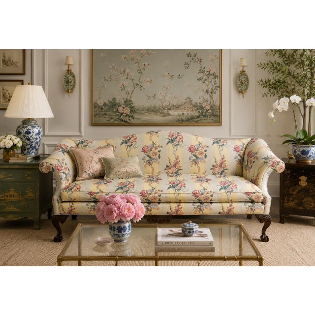 Bring timeless elegance to your space with this beautifully crafted vintage camelback sofa, featuring classic Chippendale-...