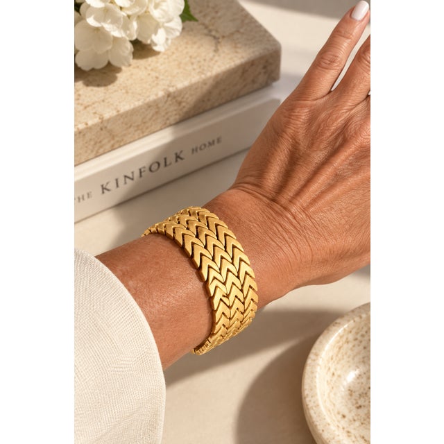 An exceptional Italian 18K yellow gold bracelet from circa 1970, designed as three articulated rows of sculptural chevron...