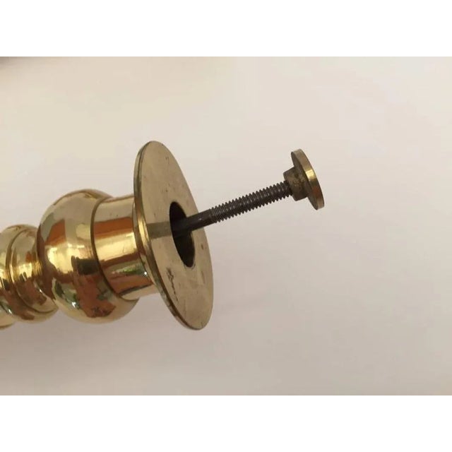 Pair of Victorian polished brass candlesticks with push ups. Measures: Height 9.25”, base 5.5”. Hand tooled heavy brass,...