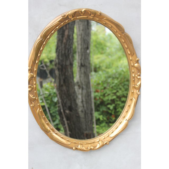 Vintage wall oval mirror. Resin ornate frame gold gilt bronze baroque solid frame. Belgium mirror. This frame mirror is...