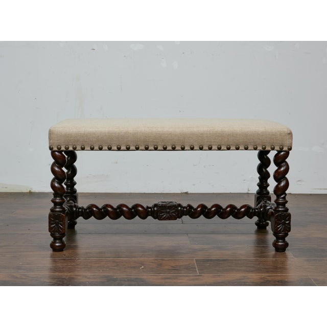 An English barley twist bench from circa 1900, built on a dark oak frame with the deep, tight spirals typical of late...