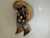 A vintage multi-dimensional floral and ribbon brooch, featuring a central flower with a small pearl accent and sweeping...