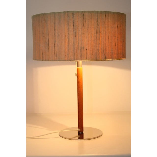 Brass nickel -plated, leather handle, original fabric shade, 2 versions E 27, train switch on the lamp This piece has an...