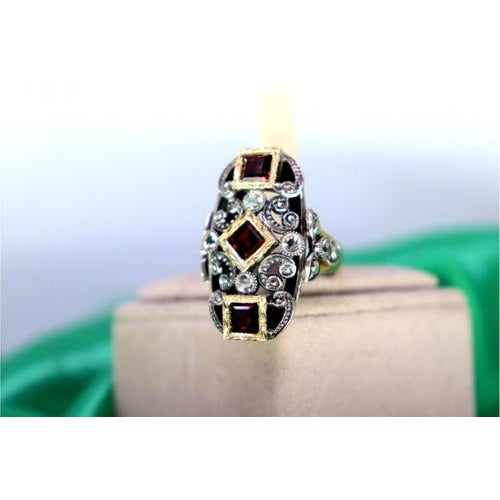 Gold and Silver Ring with Inlaid Zirconias and Calibrated Garnets, in Very Good conditions. Designed from 2000 This piece...