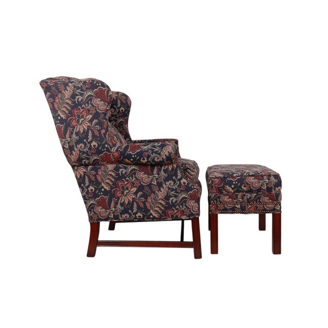 An English Georgian style wingback chair and matching ottoman made by Bradington Young of North Carolina. Curvaceous wings...