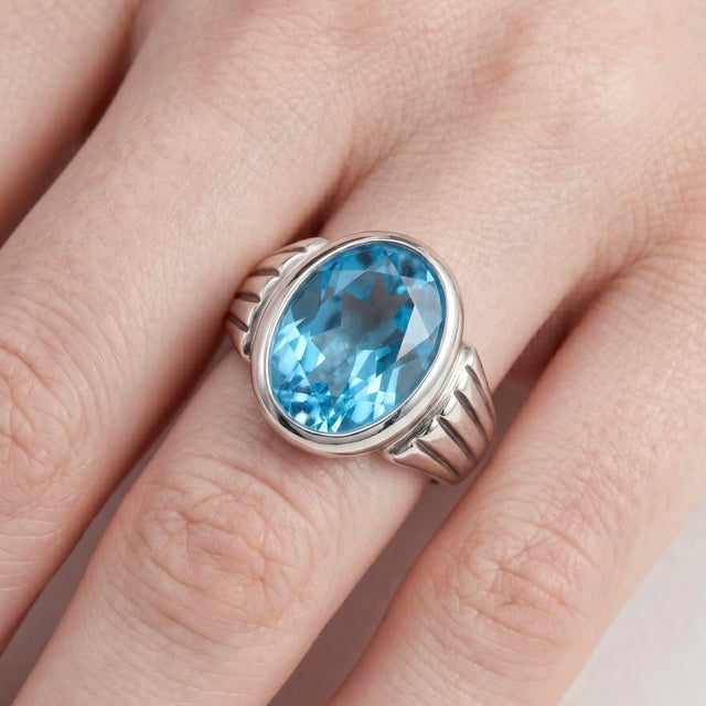 Make a bold and refined statement with this striking Blue Topaz ring, a perfect blend of modern elegance and timeless...