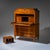 Biedermeier secretary desk raised on tapered square legs, featuring a three-drawer commode base and a flat fall-front...