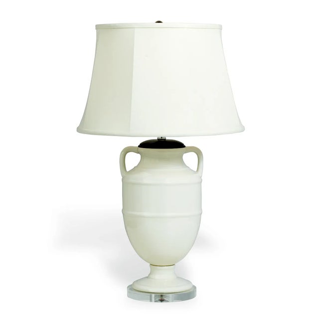 Port 68 Lantana features a classic trophy handled shape body in cream/ivory crackled porcelain. Wood cap and Lucite base....