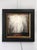 This artwork depicts a hauntingly ethereal landscape, where skeletal trees rise against a fog-laden backdrop, creating a...