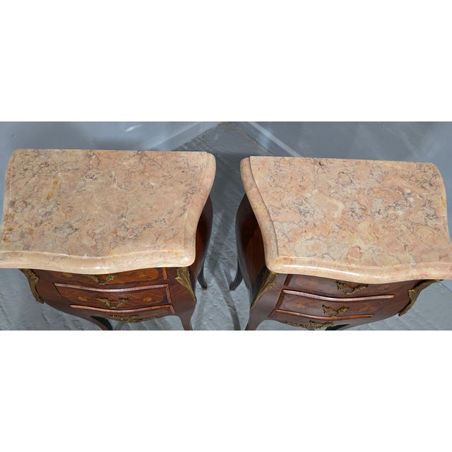 A very nice pair of French tulipwood and ormolu mounted three drawer bedside lamp chests of drawers with wonderful marble...