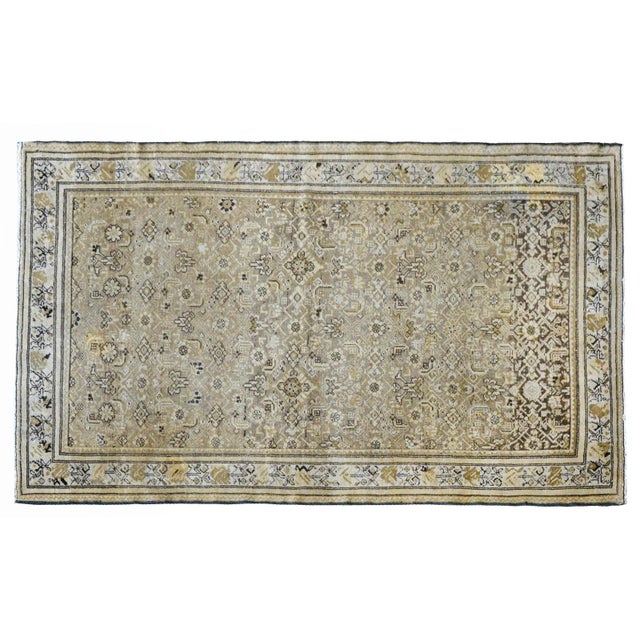 A wonderful mid-20th century Persian Malayer rug an all-over floral pattern woven in muted browns, tans, grays, and golds,...