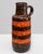 This 20th-century German ceramic vase, marked W. Germany, exemplifies the bold artistry of the fat lava era. The piece...