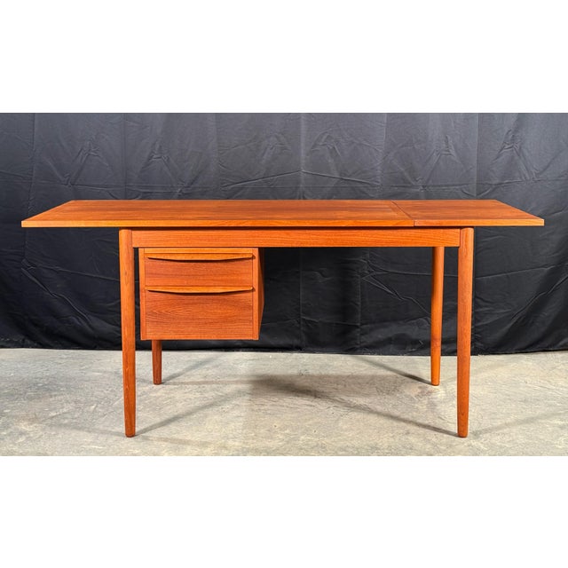 This clean-lined Danish teak desk has a drop-leaf extension on the right side that nearly doubles the work surface when...