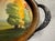 Art Nouveau oval serving tray with reverse-painted landscape scene and ornate Art Nouveau/Art Deco metal handles. The tray...