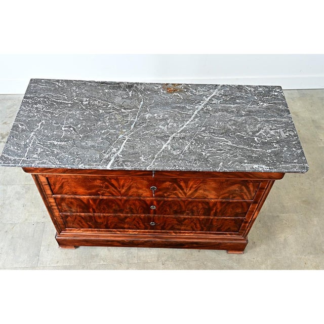 A beautiful Louis Philippe commode from 19th-century France. The top is made from a single slab of Sainte Anne marble with...