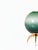 A chic Italian console lamp, newly made. Each lamp has a green ombre murano glass globe that sits atop a brass tripod base.