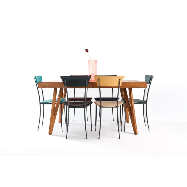 Arper made chairs that understood the assignment: get out of the way and let the leather do the talking. Slender black...