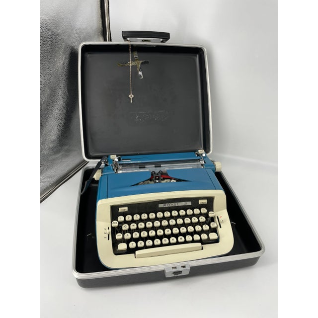 Sleek Mid Century Modern Royal Precision Portable typewriter in bright blue and antique white two toned body. Includes...