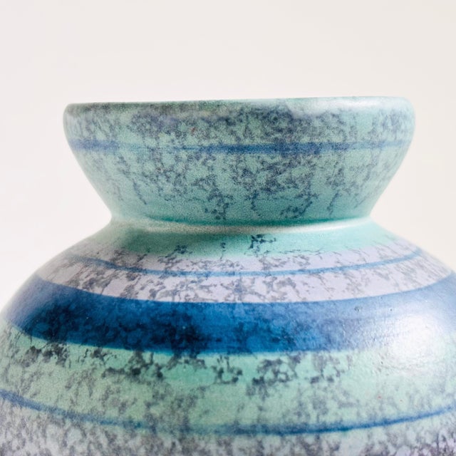 A lovely vintage pottery vase with a speckled blue and purple striped glaze.