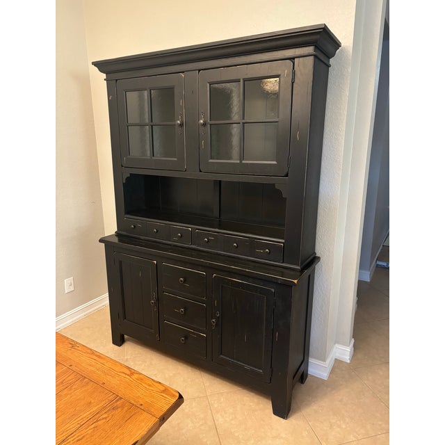 Solid-wood two-piece hutch features a rich, factory-distressed black finish with antique-style hardware, making it a...