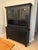 Solid-wood two-piece hutch features a rich, factory-distressed black finish with antique-style hardware, making it a...