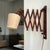 Vintage wooden scissor wall lamp featuring an adjustable accordion-style extension arm. The articulated wooden mechanism...
