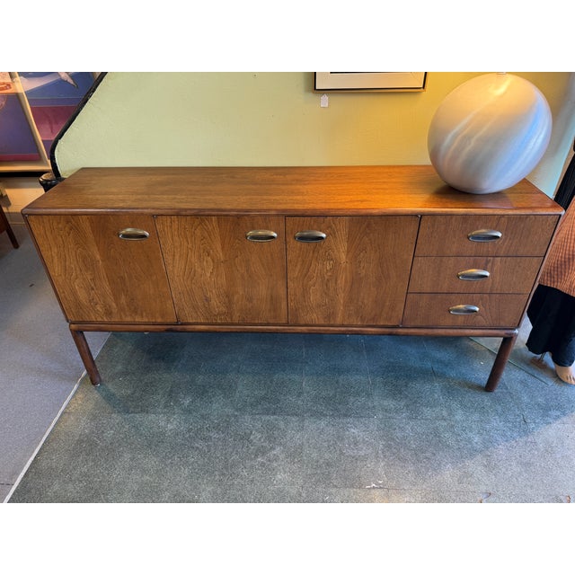 You are viewing a very cool Combed Walnut Credenza c1960s. This sleek credenza is made of combed walnut throughout, with...