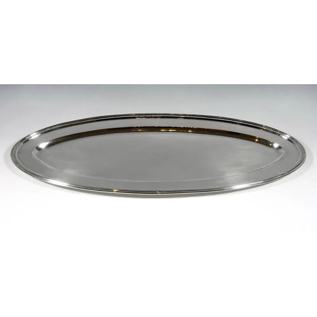 Oval shaped silver platter in a smooth, simple design with a profiled edge. Branded by the Diana's head mark, the Viennese...
