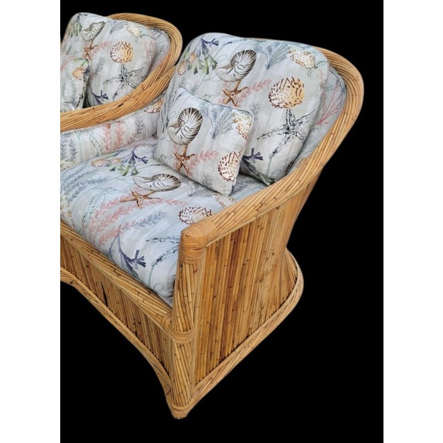 An incredible set of vintage pencil reed extra large lounge chairs with matching ottomans. Both the chairs and ottomans...