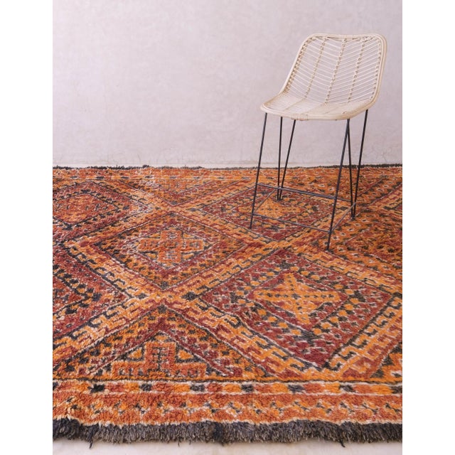 This rare vintage Beni M'Guild rug measures 12.3 by 7.1 feet and exemplifies traditional Amazigh craftsmanship. Its...