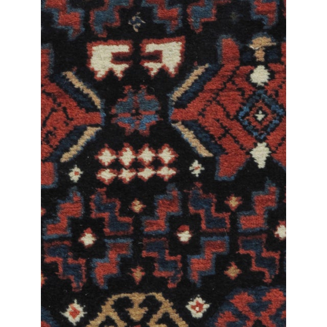 From N.W. Persia a lovely antique hand knotted wool runner. Colors navy/multi.
