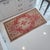 This charming vintage Oushak mat features a soft, sun-faded rose palette that brings a touch of soulful warmth to any...