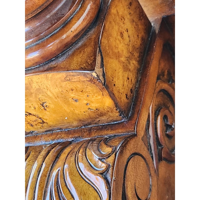 Polished round dining table has a burl wood veneer top with a high-gloss finish. The base is a four-column pedestal with...