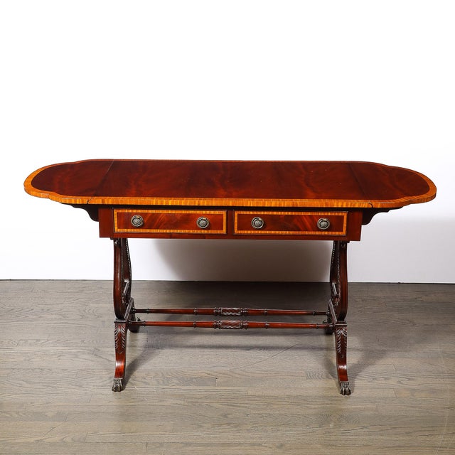 This Edwardian writing desk, crafted in mahogany with inlaid exotic wood detailing and bronze pulls, hails from America...