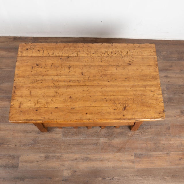 20th century rustic coffee table from Hungary with base uniquely constructed using old vice elements, creating an...