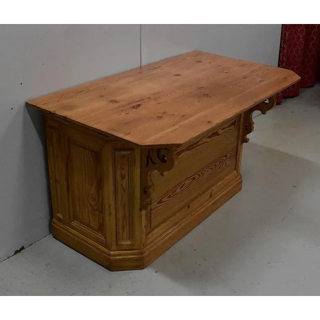 Shop counter in Natural Pine, with cut front corner top. This top is wider on the left than it is on the right. It is...