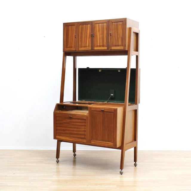 This mid-century vinyl record media cabinet was custom made in England during the 1960s. Typical of the period, it was...
