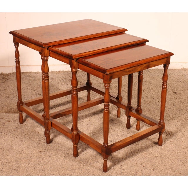 A delightful set of three nesting tables with foliage decoration from the early 20th century. Superb craftsmanship in...