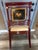 Finished in a rich lacquered red with hand-painted gold detailing, this vintage Chinoiserie-style armchair features a...