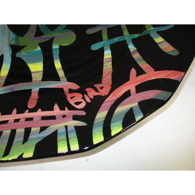 A hand-crafted large pottery hanging wall art piece. It is hand painted with an abstract design in glossy shades of blue...