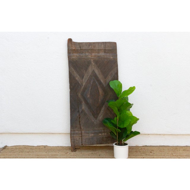 This 46-inch door (51 inches including its forked pivot tab) is a single-slab Igbo piece, hand-carved from one solid plank...