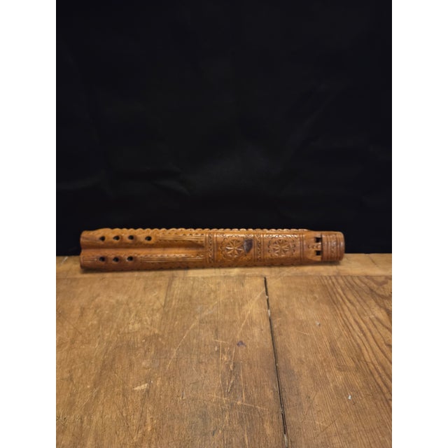 This is a dvojnice (also known as a twin or double-barrel flute), a traditional hand-carved wooden folk instrument...