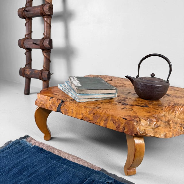 A low Japanese table that draws attention to the wood’s irregular shape and grain. Dimensions: height 19 cm, width 69 cm,...